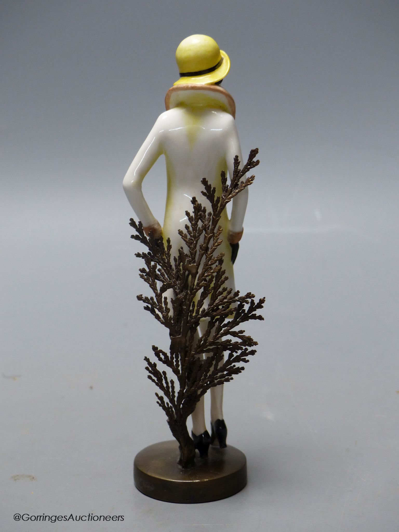 An Albany Worceter Art Deco style bronze and porcelain model of a young woman